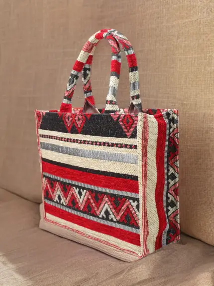 Berber pattern handbag with intricate colorful shapes ,featuring sturdy top handles and a black suede interior