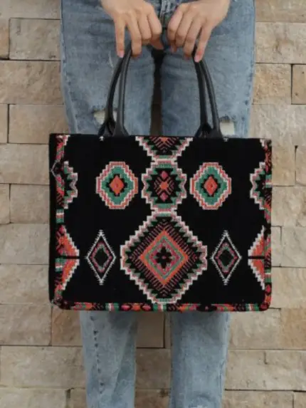 Berber pattern handbag with intricate colorful shapes ,featuring sturdy top handles and a black suede interior