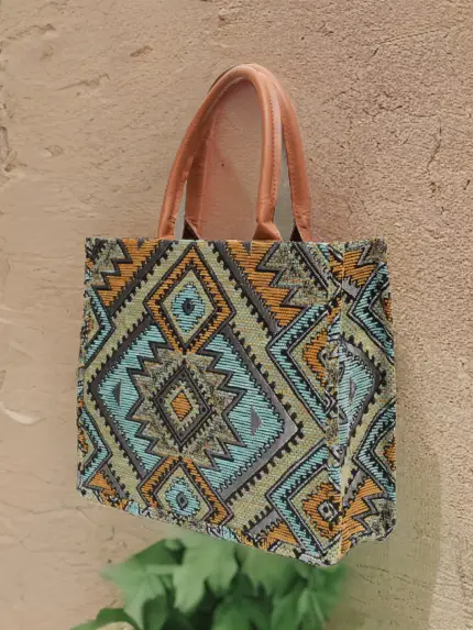 Berber pattern handbag with intricate colorful shapes ,featuring sturdy top handles and a black suede interior