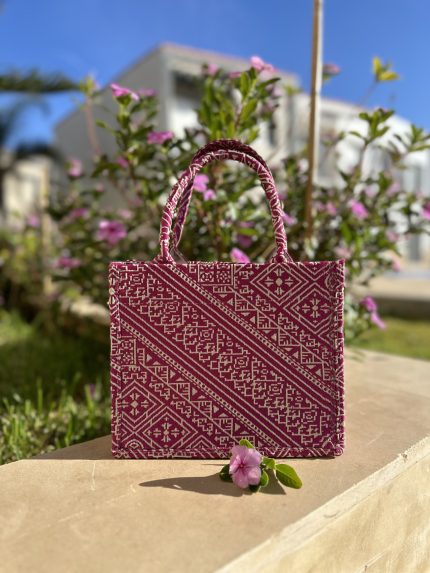 Fuchsia embroidered handbag with intricate Fassi patterns, featuring sturdy top handles and a black suede interior