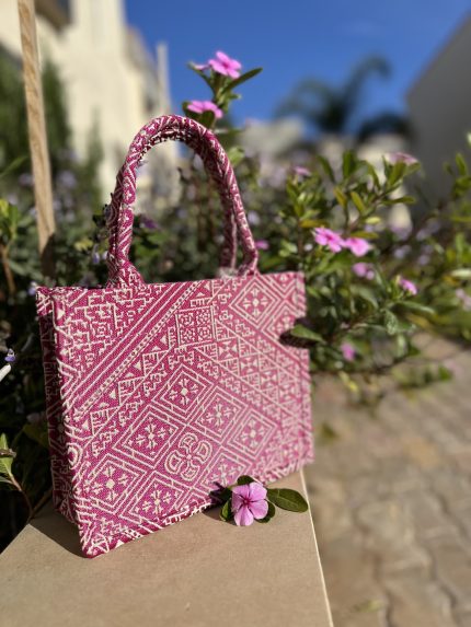 Fuchsia embroidered handbag with intricate Fassi patterns, featuring sturdy top handles and a black suede interior