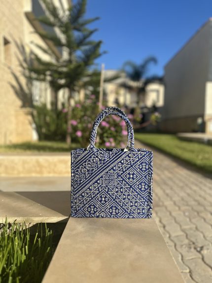 blue embroidered handbag with intricate Fassi patterns, featuring sturdy top handles and a black suede interior